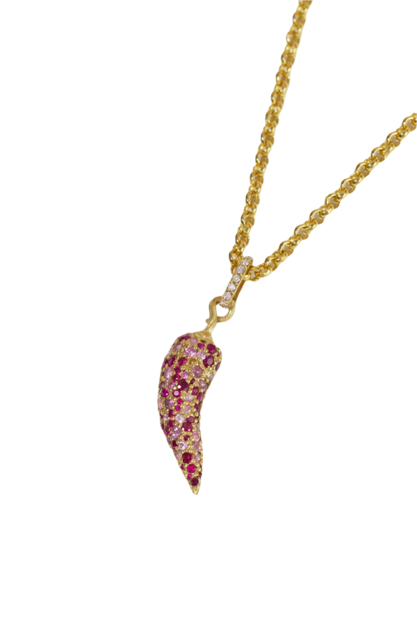 Gold necklace with a pink gemstone pendant on a white background