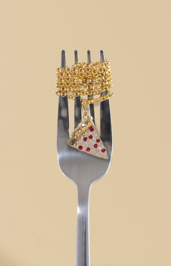 Gold chain with a pizza slice pendant wrapped around a fork against a beige background